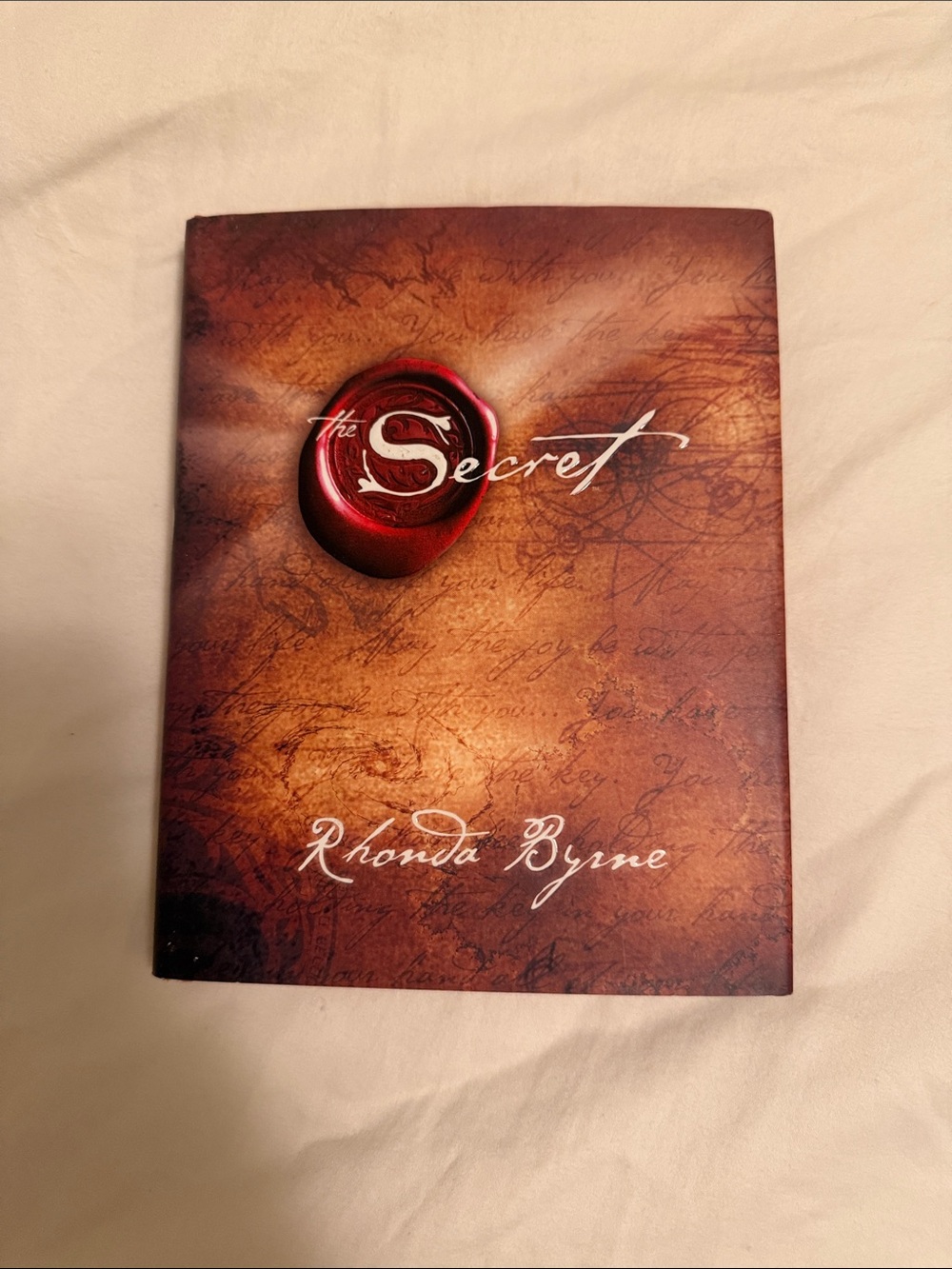 The Secret by Rhonda Byrne - Brown Cover with Red Seal